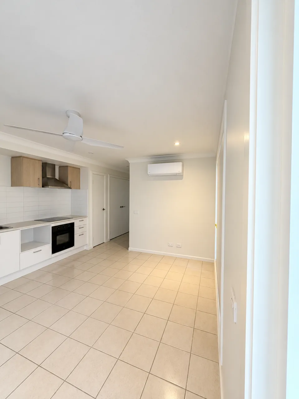Apartment kitchen and tiled living area after cleaning