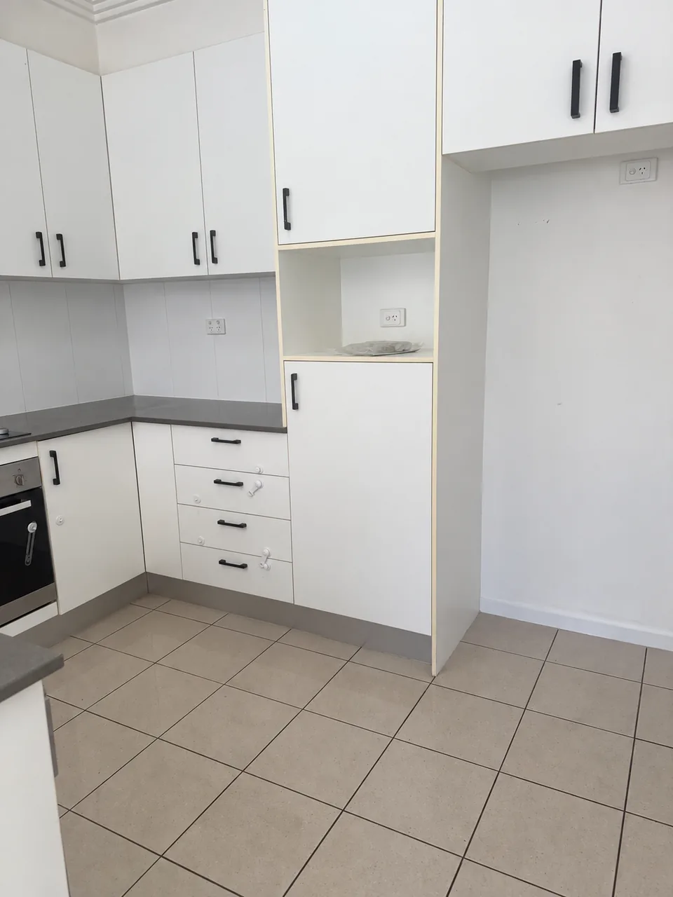 Kitchen cupboards, sink and benchtop after cleaning